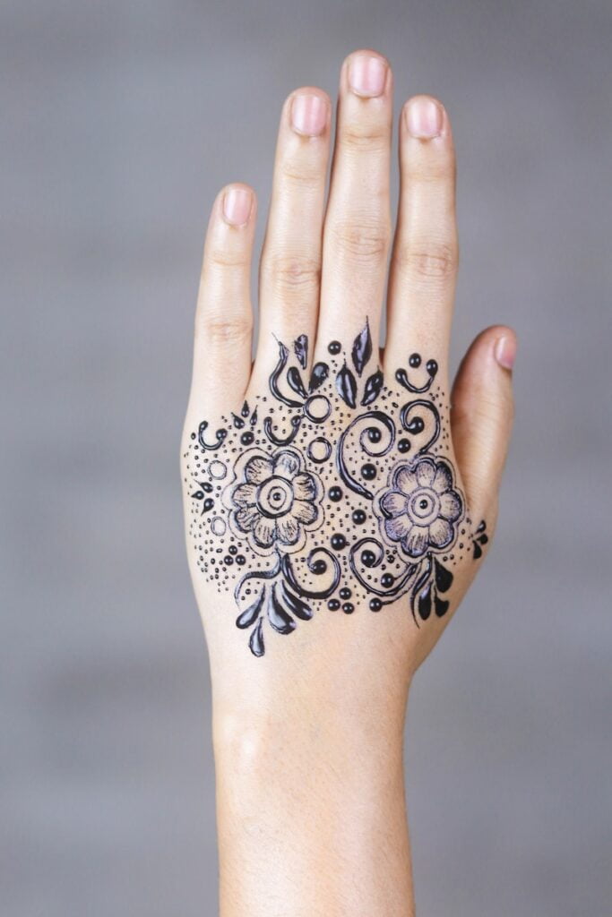 black floral hand tattoo art