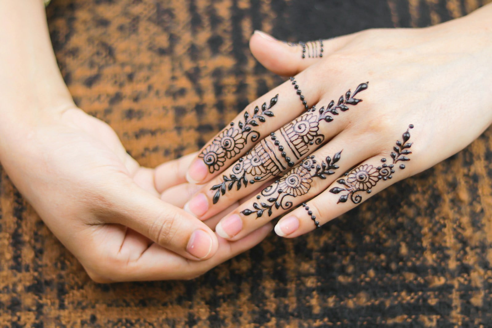 person with black and white tattoo on hand